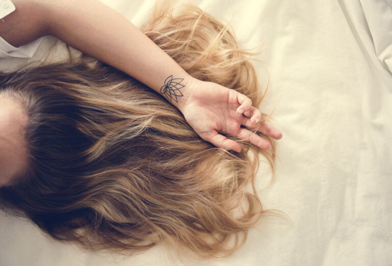 woman with brunette hair lying down on the bed 2023 11 27 04 53 01 utc